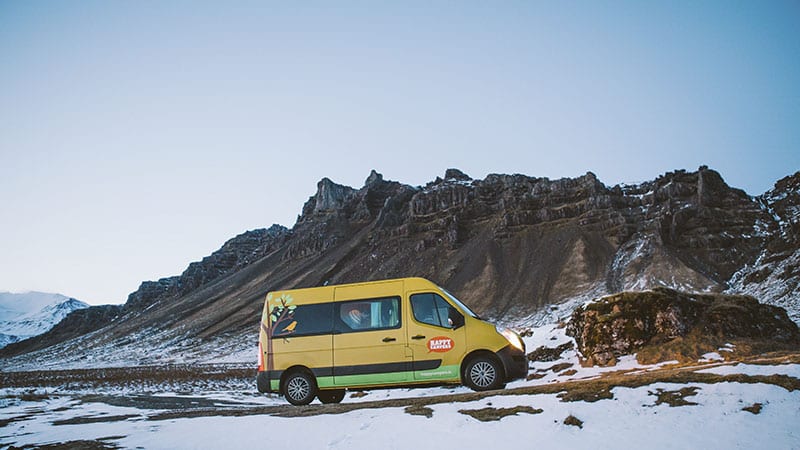 Campervan parked in front of mountains