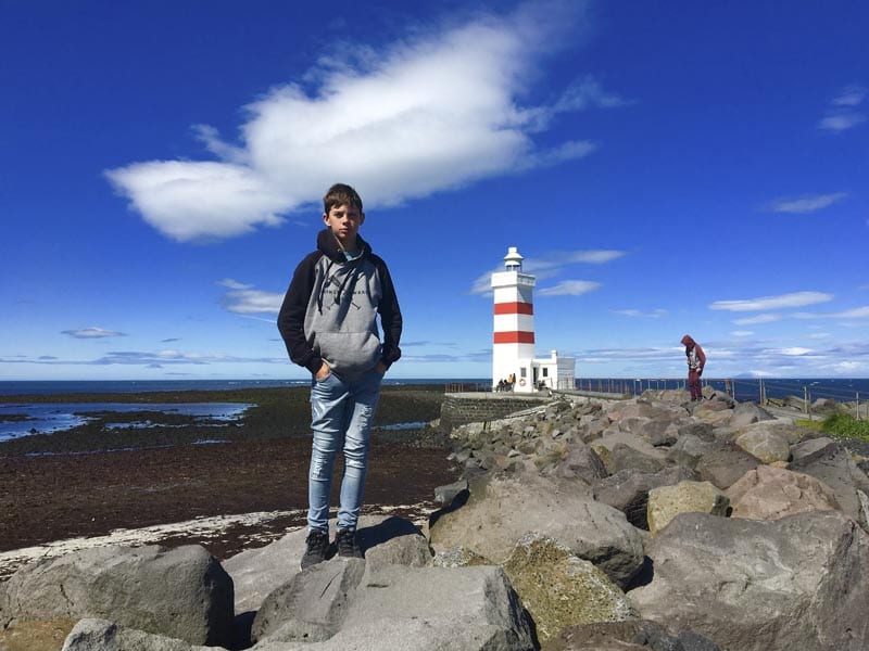 A boy standing in front of Reykjanesviti
