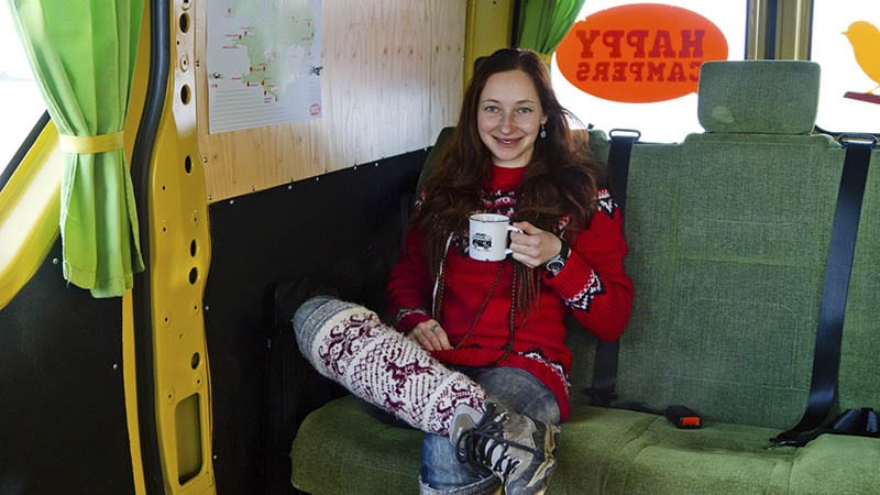Female drinking coffee in a camper