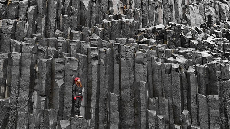 Woman standing on basalt columns