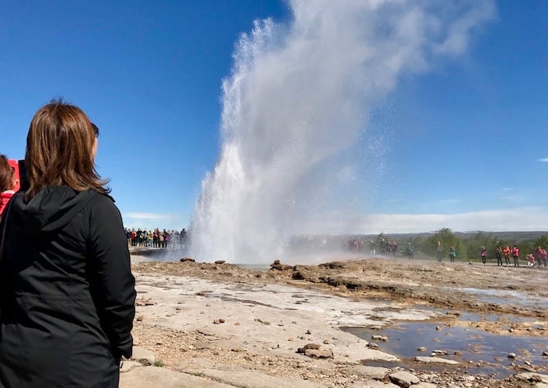 Woman watching geysir erupt