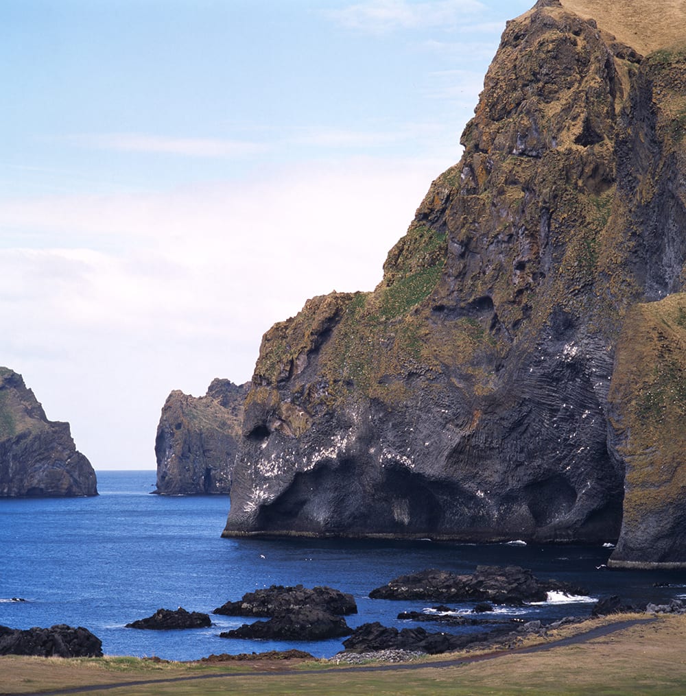 Rock formation looking like an elephant on the shores of the island surrounded by more rock  formations and cliffs