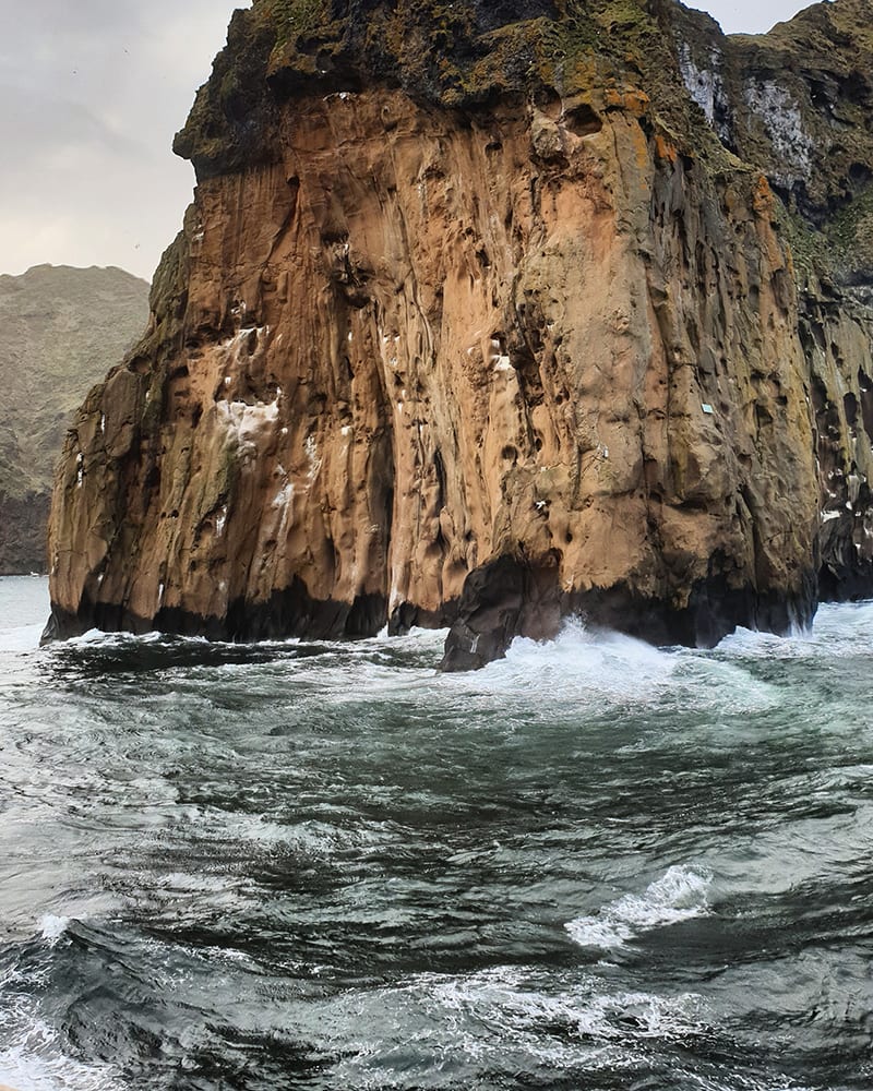 rugged steep cliffs surrounded by ocean