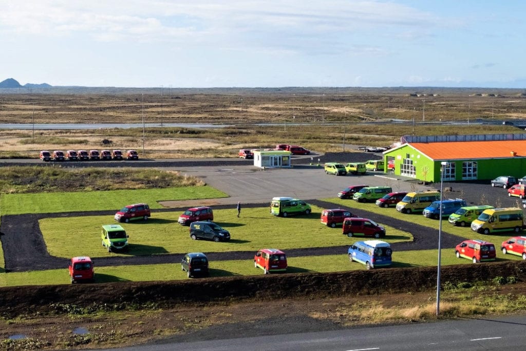 aerial shot of a campsite with campervans parked on the grass