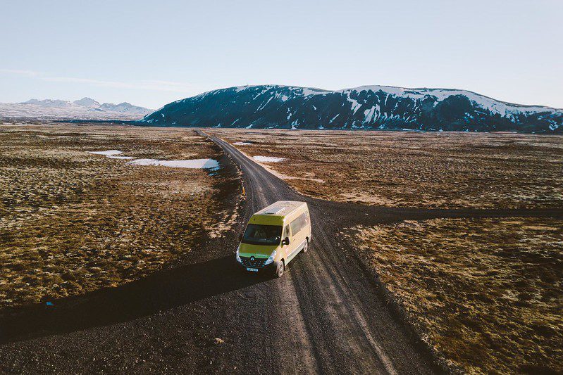 Yellow campervan on a gravel road