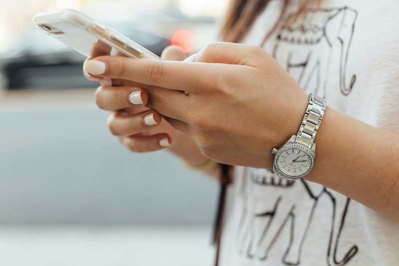 woman's hands holding a smart phone 