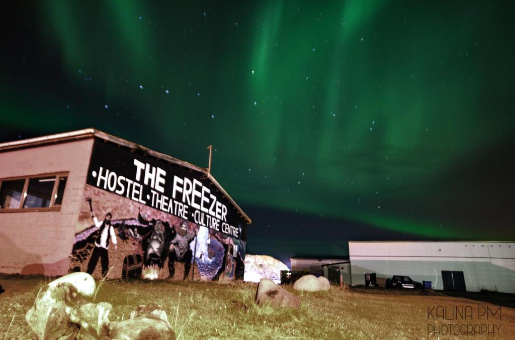 Northern Lights above Freezer Hostel and Culture Center Mural in Iceland