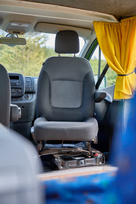 Front passenger seat of the Happy 2 EX campervan, shown swiveled to face the living space—adding comfort and functionality for your Iceland road trip.